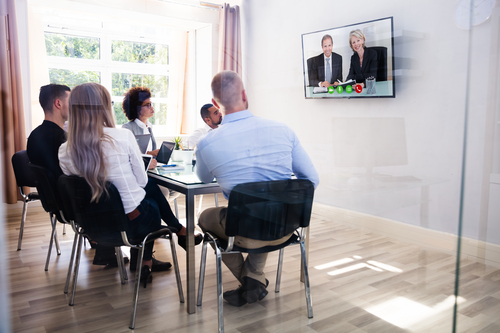 group of diverse businesspeople video conferencing in boardroom